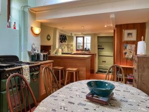 a kitchen with a table with a bowl on top of it at Bonsall View Cottage in Bonsall