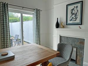 a dining room with a table and a fireplace at Poppy Cottage in Eryholme