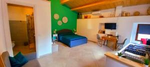 a living room with a green wall at Sant'Elia B&B in Alessandria del Carretto +27 photos