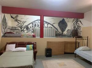 a bedroom with two beds and a mural on the wall at Wahnon Guesthouse in Paul