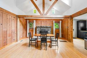 a kitchen and dining room with a table and chairs at Pet Friendly Creekside Cabin At Darlington in Ligonier