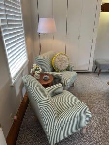 a living room with two chairs and a table at Large, Bright Suite Kitchenette in Ligonier
