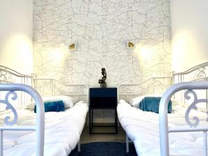 a room with two beds and a wall with a mural at Cozy Hideout - Condo Hotel in Timişoara