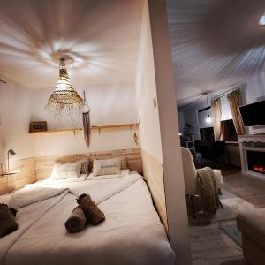 a bedroom with a large white bed with two shoes on it at Koje1 in Bremm