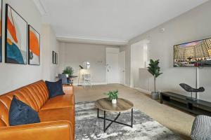 a living room with a couch and a table at 1BR Calm, Cozy & Furnished Apt in Hyde Park - Windermere 402 in Chicago