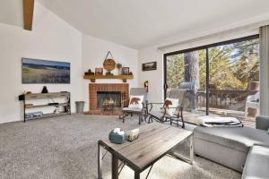 a living room with a couch and a fireplace at Restmoore Big Bear~ Lakeside Condo Retreat~ in Big Bear Lake