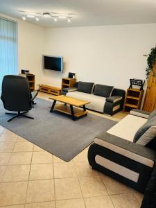 a living room with a couch and a table at Ferienwohnung Marienau in Coppenbrügge
