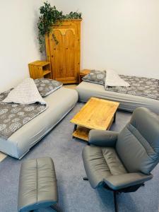 a room with three beds and a couch and a table at Ferienwohnung Marienau in Coppenbrügge