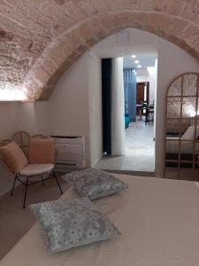 a bedroom with two pillows on a bed and a chair at Filioli 28 in Bari +13 photos