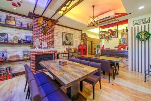 a restaurant with a table and chairs and a fireplace at 宜蘭幸福8號主題寵物友善民宿 in Wujie