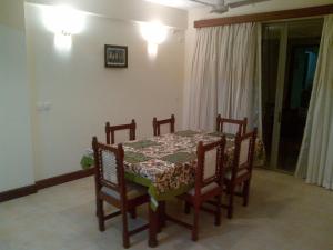 a dining room table and chairs with a table and a table and a table at Bamburi Beach Homes in Bamburi