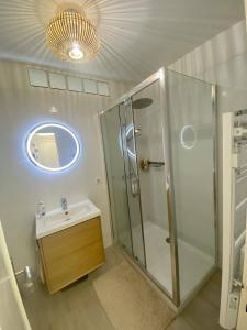 a bathroom with a shower and a sink and a mirror at Golf Juans- Studio Front de Mer, Wifi Clim in Vallauris