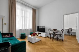a living room with a couch and a tv and a table at Luxury Apartment next to Koszykowa Street in Warsaw