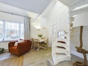 a living room with a spiral staircase and a table at “The Sleepers Cottage” 2-6 people w/ free parking in Hough Green