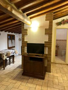 a living room with a flat screen tv on a wall at Il Nido di Fede e Romy in Castelnuovo Berardenga