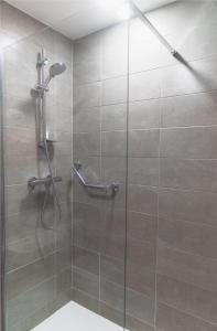 a bathroom with a shower with a glass door at Uppercross House Hotel in Dublin