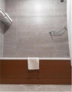 a bathroom with a bath tub with a towel at Uppercross House Hotel in Dublin