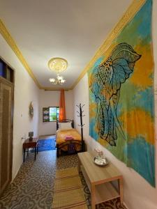 a bedroom with a bed and a painting on the wall at Dar Mora in Tangier