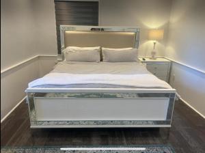 a bedroom with a large bed with a white mattress at Private Suite In Huntington Station in Huntington Station