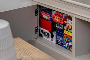 a drawer in a cabinet with a stack of games at “The Sleepers Cottage” 2-6 people w/ free parking in Hough Green +31 photos