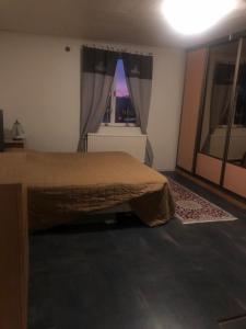 a bedroom with a large bed and a window at bnb mary in Björnlunda