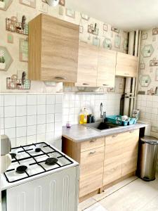 a small kitchen with a stove and a sink at Appartement de 3 chambres in Ris-Orangis