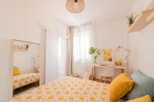 a small bedroom with a bed and a desk at Brand new stylish ,spacious and cosy room with en suite bathroom in Madrid