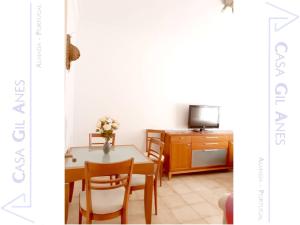 a dining room with a table and a tv at Casa Gil Anes in Almada +35 photos
