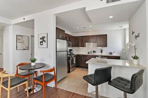 a kitchen with a table and chairs and a refrigerator at Stylish 2BR Retreat in Hyde Park - Shoreland 1320 in Chicago
