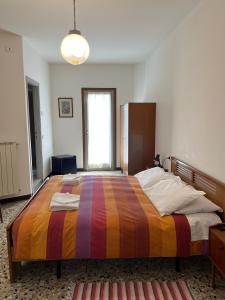 a bedroom with a large bed with a colorful blanket at Hotel Aurora in Colico