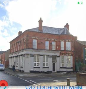 a large brick building on a city street at Selwyn Stays in Liverpool