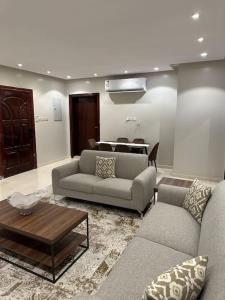 a living room with two couches and a table at وحدة سكنية فاخرة 2 Luxury residential unit in Medina