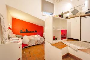 a room with a bed and an orange wall at Dimora Pastini in Rome