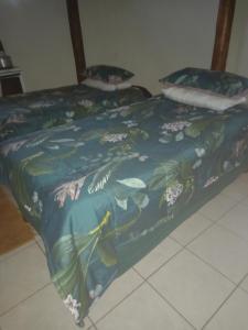 a bed with a mermaid themed comforter and pillows at Rheotessa Deben in Dagbreek