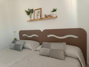 a bedroom with a bed with two pillows on it at Apartamento céntrico La Morada Santanderina in Santander