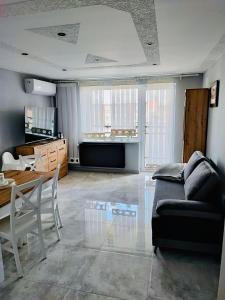 sala de estar con sofá y mesa en Apartament Kościuszko, en Głogówek