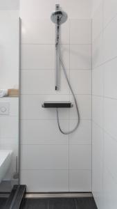 a shower with a shower head in a bathroom at HomeSweetHome Wedel in Wedel