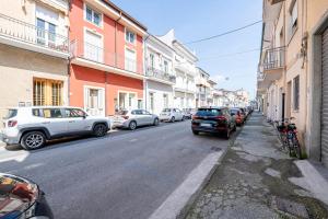 a street with cars parked on the side of the road at Attico Viareggio Centro in Viareggio