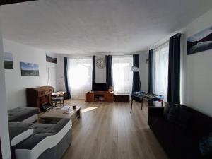 a living room with a couch and a table at Gite du moulin in Gunsbach