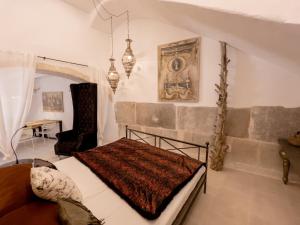 a bedroom with a bed and a chair in a room at Casa Timbale in Felanitx