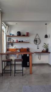 a kitchen with a wooden table and some chairs at Segunda Casa in Paraty