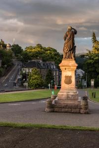 a statue of a woman standing on a street at Bed on the Brae in Inverness