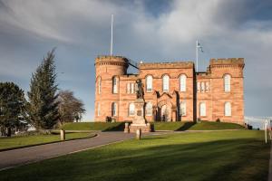 a large brick building with a flag on top of it at Bed on the Brae in Inverness