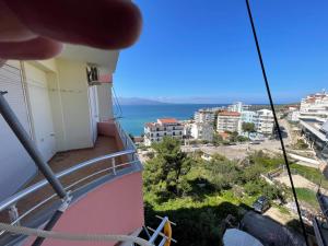 a view of the ocean from a balcony of a building at Andrea apartment in Saranda in Sarandë