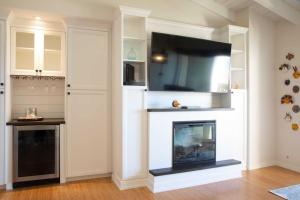 a living room with a fireplace with a flat screen tv at Solana Beach Sol condo in Solana Beach