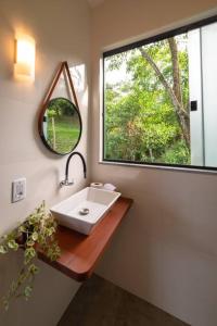 a bathroom with a sink and a window at Segunda Casa in Paraty