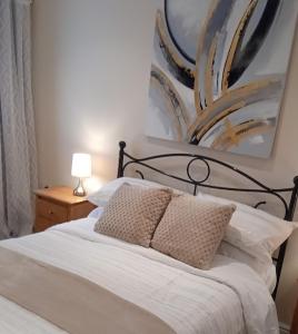 a bedroom with a bed and a painting on the wall at The Old Fire Station in Tregaron