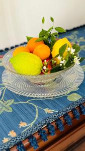 a bowl of oranges and lemons on a table at 301B&B in Palermo