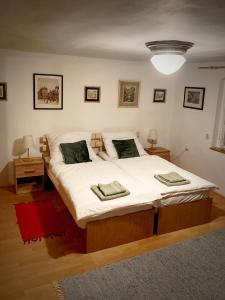 a bedroom with a large bed with white sheets at Vila Historica Karlovy Vary in Karlovy Vary