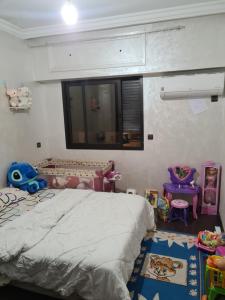 um quarto com uma cama e muitos brinquedos em Res Brahim AL Farrah em Casablanca